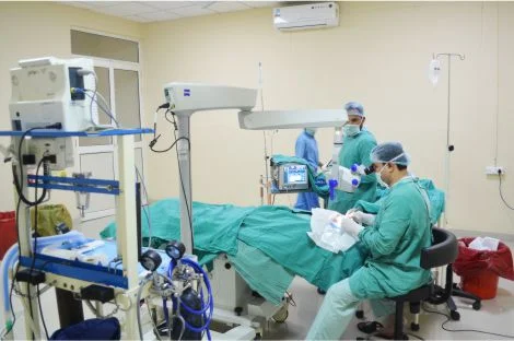 several doctors performing surgery in a room