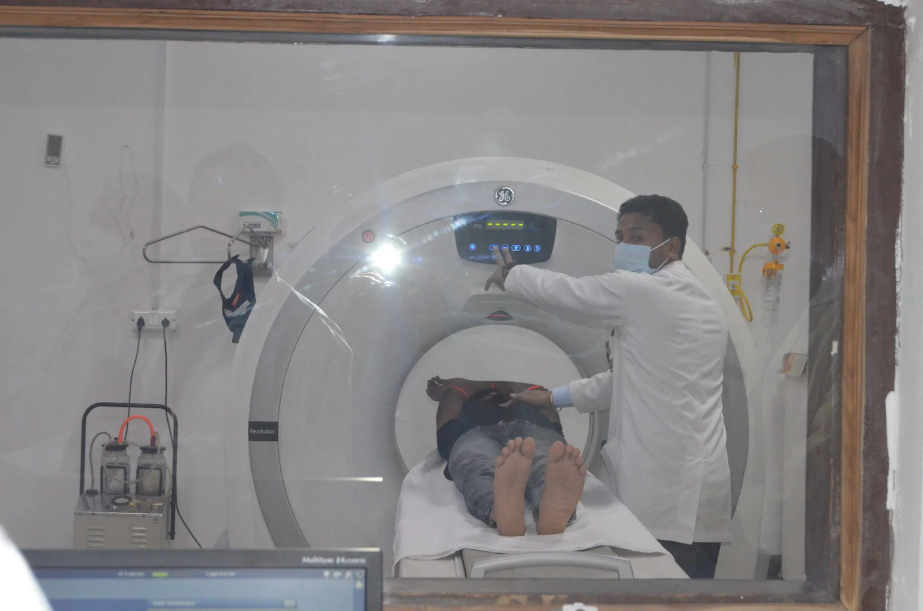 Two people and CT Scan Machine at GS Hospital