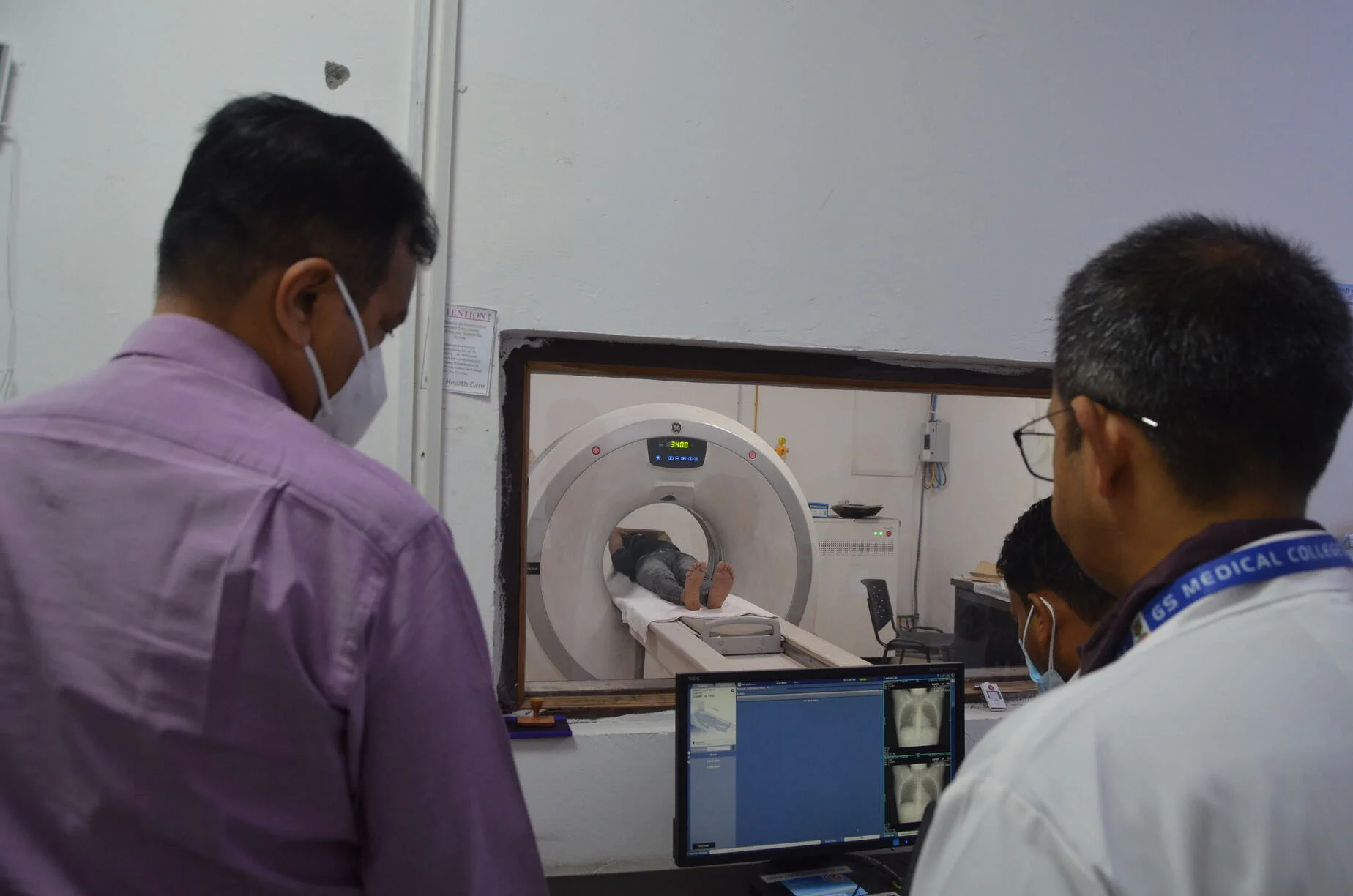 Two people and CT Scan Machine at GS Hospital